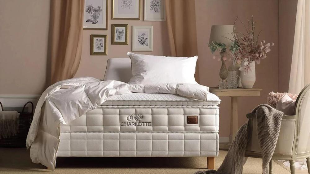 white quilt and pillows on the bed