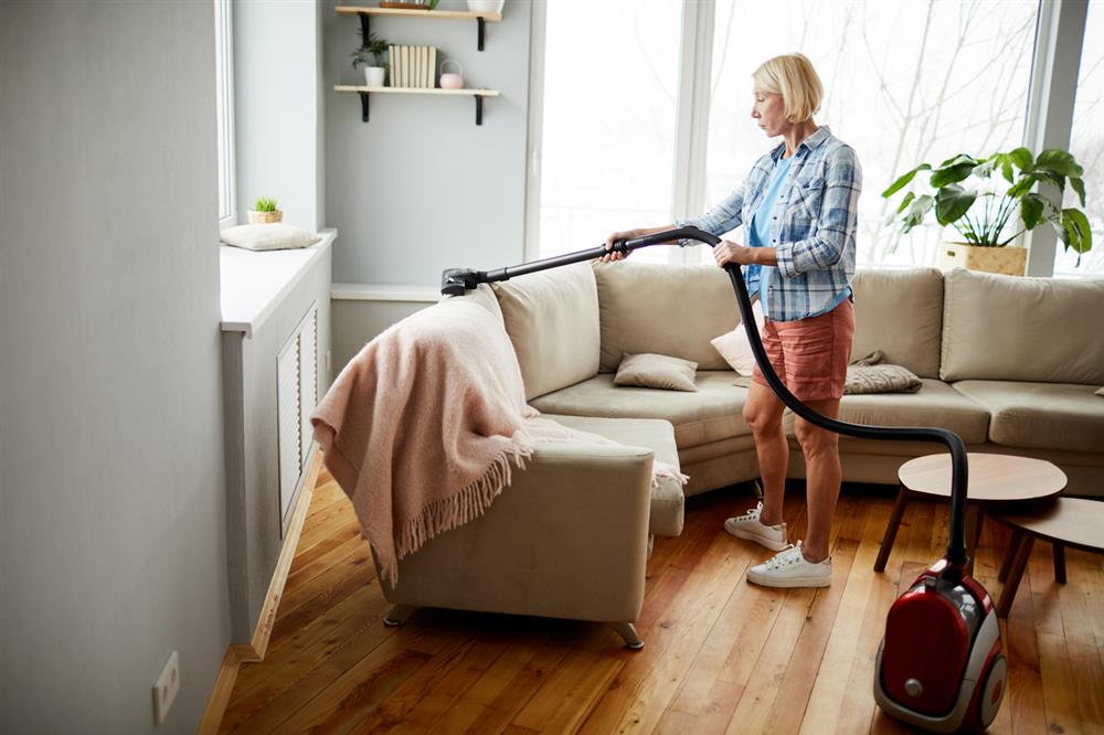 woman-vacuuming-the-sofa