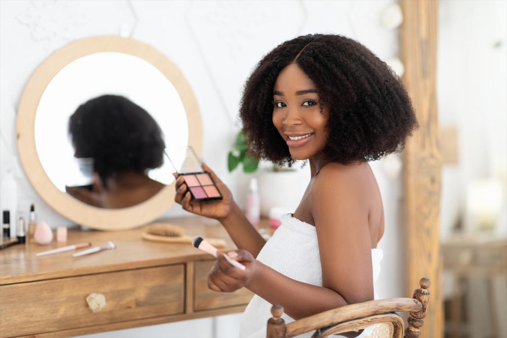 black woman applying makeup 