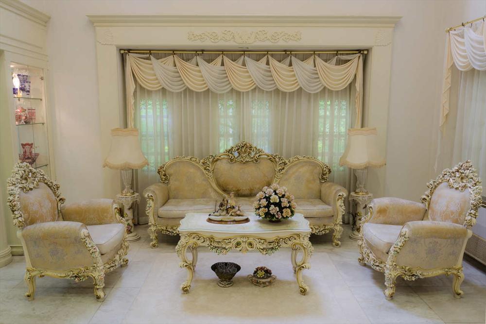 barocco style livingroom with gold detailed curtain rods