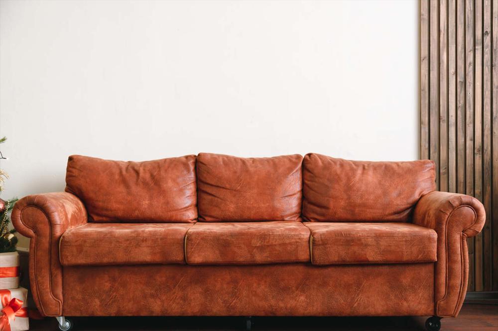 orange leather sofa with white wall