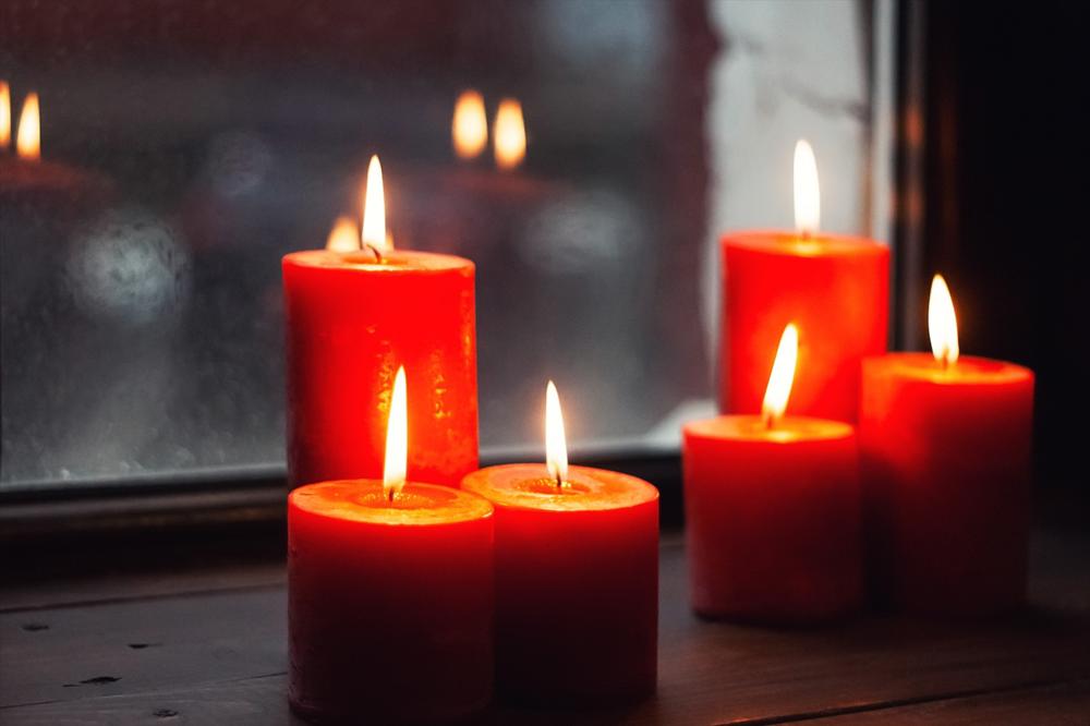 red candles on a windowsill